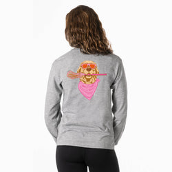 Girl wearing a gray lnog sleeve tee with a design on the back of a golden retreiver wearing pink sunglasses, a bandana, and holding a lacrosse stick, against a white backdrop.