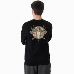 A man viewed from behind wearing a black crewneck sweatshirt with a large graphic on the back. The graphic features a deer skull, antlers, crossed lacrosse sticks, and a circular camouflage pattern.