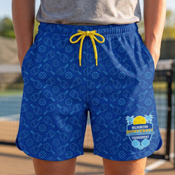 Blue shorts with paddle racket pattern and logo, worn by a person outdoors.