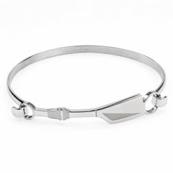 A silver-toned metal bangle bracelet with a geometric crew stick clasp and small side loops, shown on a plain white background.