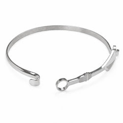 A silver-toned metal cuff bracelet with a circular ring detail and a small decorative tab, shown on a plain white background.