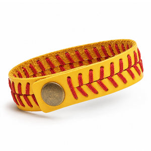 A yellow leather bracelet designed like a softball, featuring red stitching and a round metal snap closure, shown on a white background.