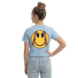 Person wearing a light blue t-shirt with a smiley face design on the back, standing against a white background.