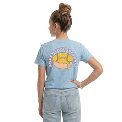 Person wearing a light blue t-shirt with a softball donut graphic and text on the back, standing against a white background.