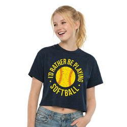 Girl wearing a navy blue t-shirt with a yellow softball graphic and text on a white background