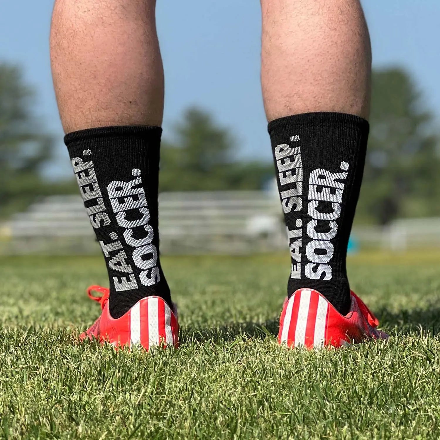 Person wearing black socks with 'Eat