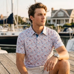 Person wearing a patriotic themed polo shirt with soccer pattern design on a pier.