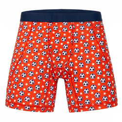 Red spandex shorts with soccer ball and star pattern on a white background