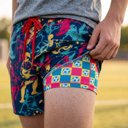 Colorful soccer patterned shorts with a checkered design on a blurred natural background