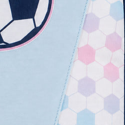 Close-up of a light blue fabric item with a soccer ball graphic and a hexagonal pattern panel in pastel pink, lavender, and light blue.
