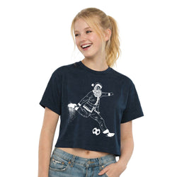 Young girl wearing a navy blue t-shirt with a graphic of Santa Claus playing soccer, on a white background.