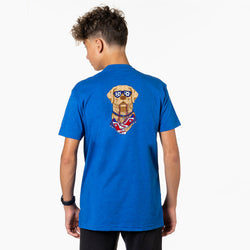 Person wearing a blue t-shirt with a soccer dog graphic on the back, standing against a white background