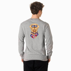 Person wearing a gray long-sleeve shirt with a soccer dog graphic on the back, standing against a white background.