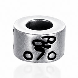 A cylindrical sterling silver bead with a central hole, featuring an engraved black symbol and small circular details on its side, set against a plain white background.