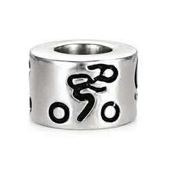 A sterling silver cylindrical bead with black oxidized details, featuring a stylized symbol and circular cutouts, shown on a white background.