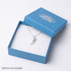 A silver angel wing pendant necklace displayed inside an open textured blue gift box with a white insert. The lid of the box is propped behind it, showing a debossed circular logo.
