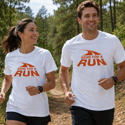 A man and a woman jogging outdoors on a forest path, both wearing white short-sleeve T-shirts with an orange graphic and the text 'GONE FOR A RUN'.