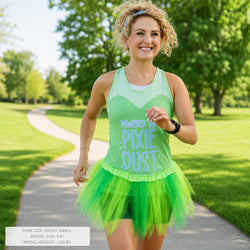 A woman jogging outdoors on a park path wearing a bright green tank top with the text 'POWERED BY .PIXIE DUST' and a matching green tutu skirt.