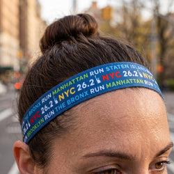 Person wearing a colorful headband with NYC running event text.