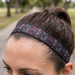 Person wearing a headband with motivational text in an outdoor setting