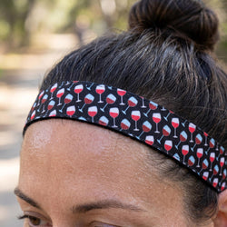 Person wearing a headband with wine glass pattern outdoors