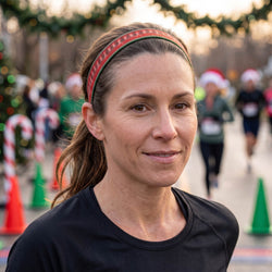 Woman wearing a red headband with a blurred festive background