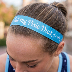 Person wearing a blue headband with 'Eat my Pixie Dust' text.