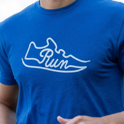 Model wearing blue shirt with a Run Shoe design