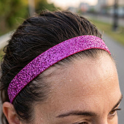Person wearing a pink glittery headband outdoors