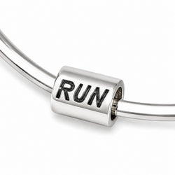 A polished silver cylindrical charm bead with the word 'RUN' engraved in black on a silver cord bracelet, shown against a clean white background.
