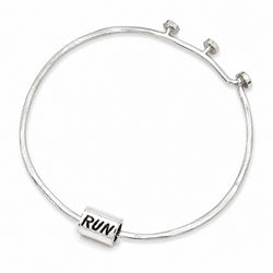 A silver bangle bracelet with a textured finish and a small rectangular charm engraved with the word 'RUN', shown on a plain white background.