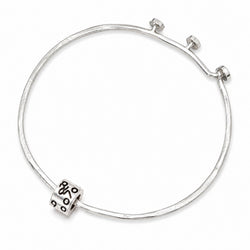 A silver bangle bracelet with a textured hammered finish and a decorative cylindrical bead featuring black circular patterns, shown on a plain white background.