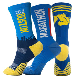 Three blue and yellow socks with marathon-themed designs on a white background
