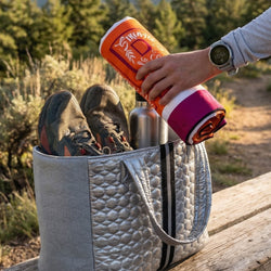 Person placing a car seat towel into a bag outdoors