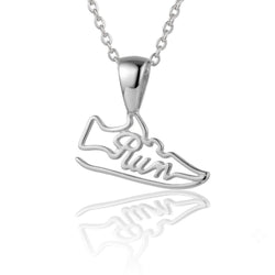 A silver necklace featuring a shoe-shaped pendant with the word 'Run' written in cursive script across the side, shown on a clean white background with a soft reflection below.