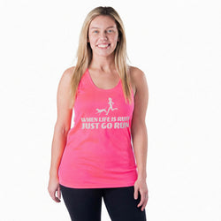 Woman wearing a pink tank top with runner and dog graphic with text