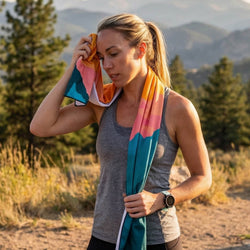 Woman with a colorful towel in a mountainous outdoor setting