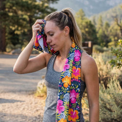 Woman with a colorful floral towel around her neck outdoors