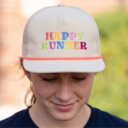 Person wearing a cap with 'Happy Runner' text in colorful letters.