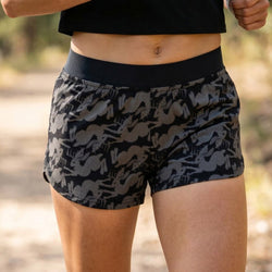 Person wearing black and gray jackalope patterned shorts with a blurred natural background