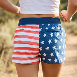 Person wearing shorts with American flag design outdoors