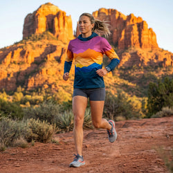 Woman wearing a running hoodie with a mountain-style design