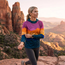 Woman wearing a mountain design running hoodie at a canyon setting