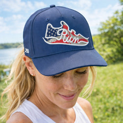 Woman wearing a patriotic cap with a logo outdoors