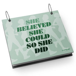 Bibfolio with 'She believed she could so she did' text on a light green background