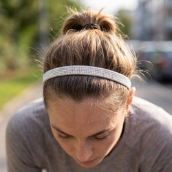Person wearing a sparkly silver headband outdoors