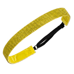 Yellow glittery headband with black strap on a white background