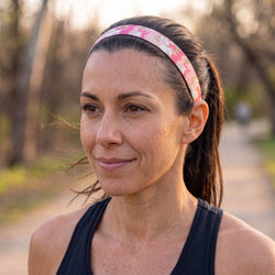 Woman wearing a pink camouflage headband outdoors