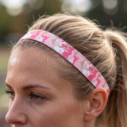Person wearing a pink camouflage headband outdoors