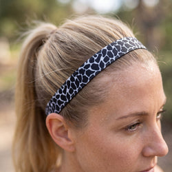 Person wearing a black and white patterned headband outdoors